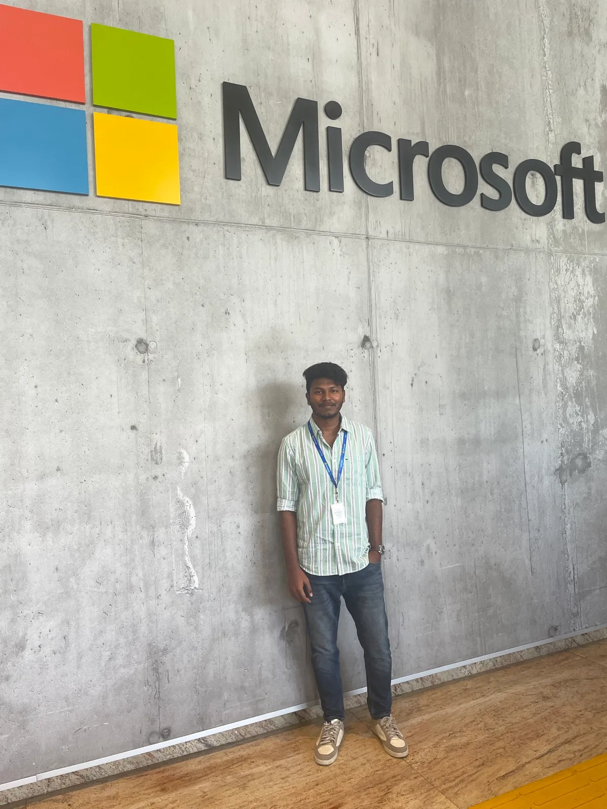 Standing under a Microsoft logo on a concrete wall
