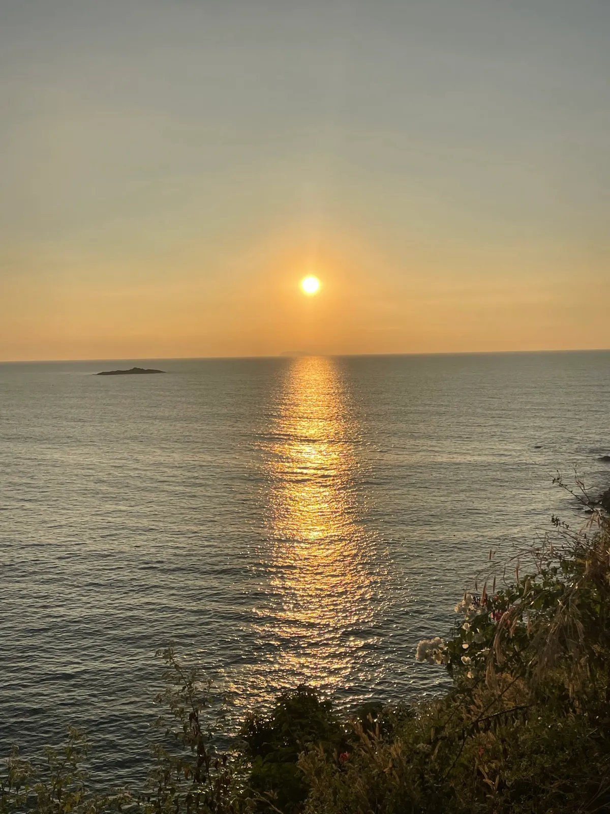 Sunset over the sea from a cliff