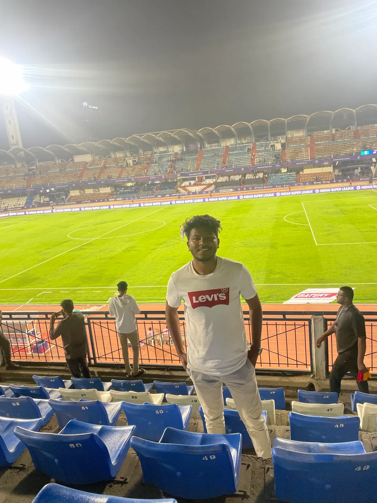 In the stands of a stadium in a Levi's t-shirt