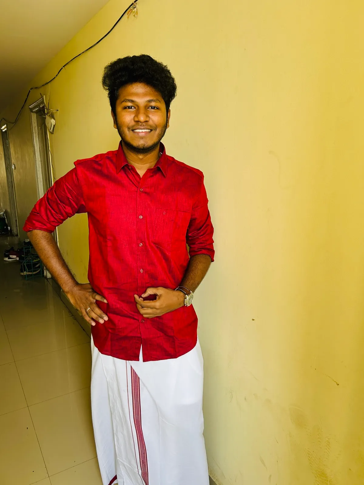 In a red shirt and white veshti