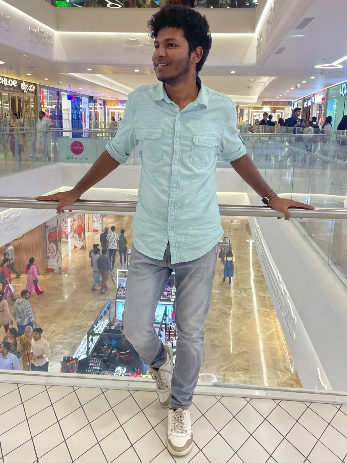 Leaning on a railing in a mall